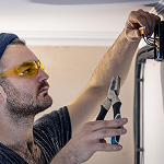 a skilled man fixing electronics appliance